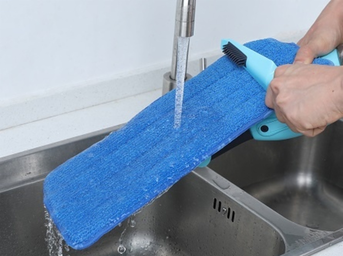 Scrub the mop head with a scrub brush to remove stubborn dirt and stains