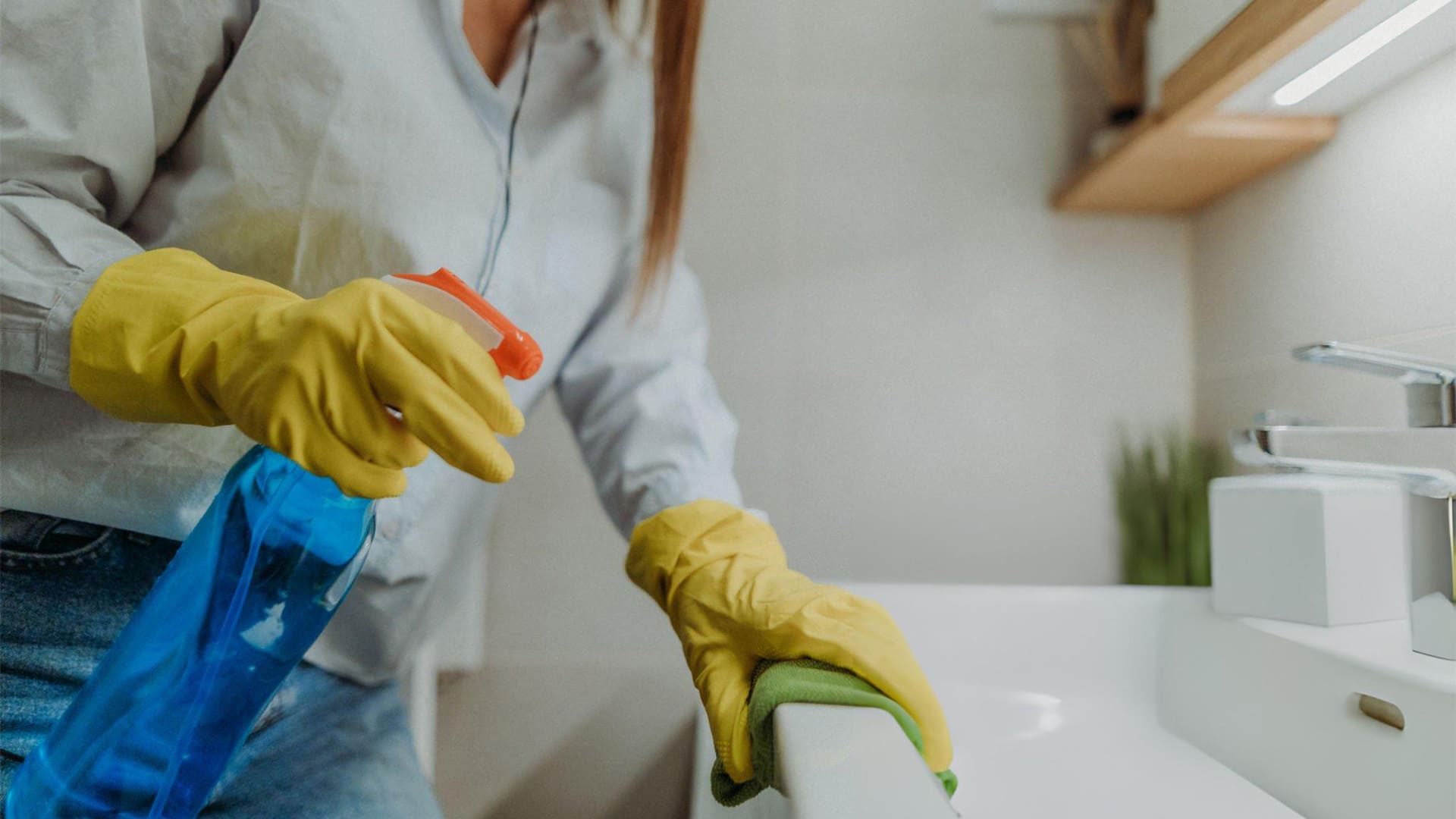 a person wearing a pair of gloves cleaning the counter